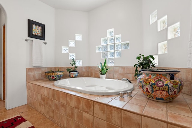 bathroom featuring tile patterned flooring and a bath