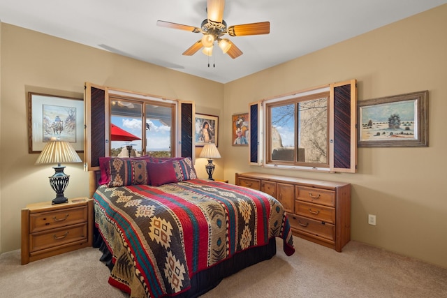 bedroom with light colored carpet and ceiling fan