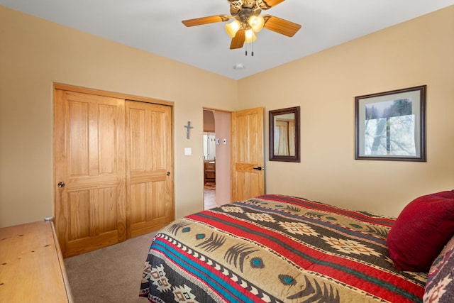 carpeted bedroom featuring a closet and ceiling fan