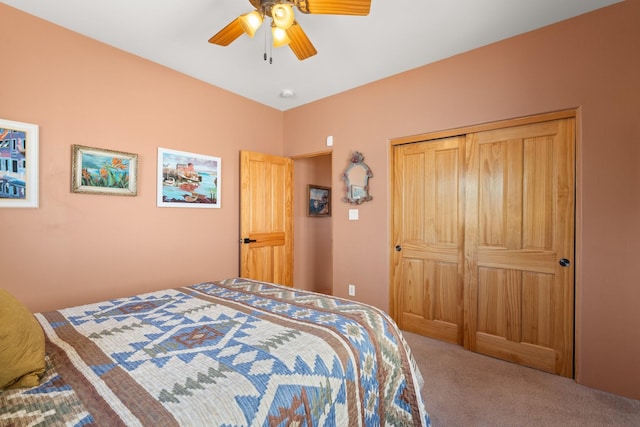 bedroom with a ceiling fan, carpet, and a closet