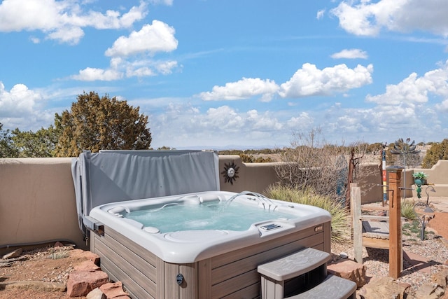 exterior space featuring a hot tub and fence