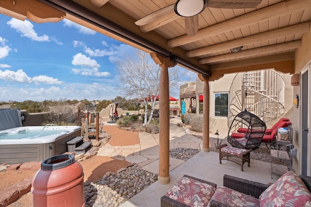 view of patio with a ceiling fan and a hot tub