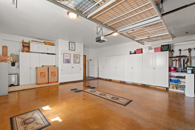 garage featuring a garage door opener and freestanding refrigerator