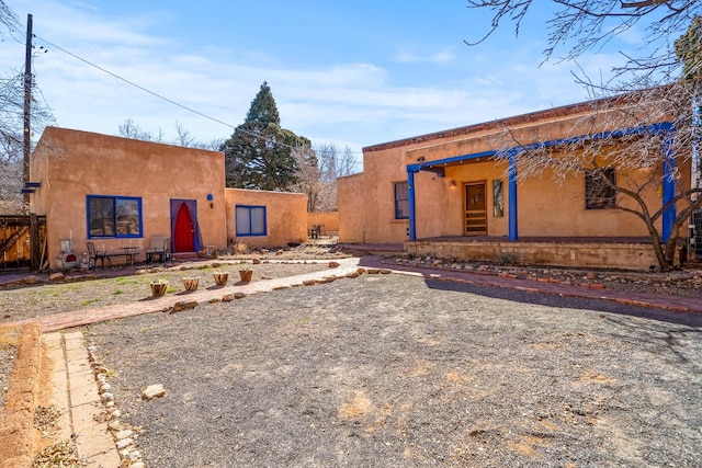 rear view of house with stucco siding