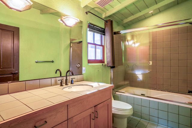 bathroom featuring visible vents, vaulted ceiling with beams, toilet, tiled shower / bath combo, and vanity