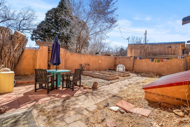 view of patio / terrace featuring a garden and fence