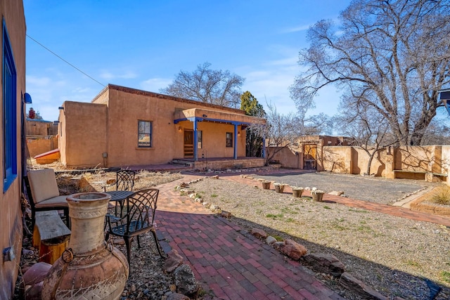 back of property featuring stucco siding, a patio, and a fenced backyard