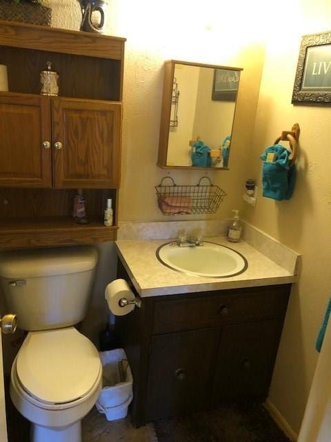 bathroom featuring toilet and vanity