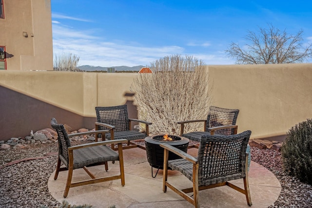 view of patio / terrace featuring a mountain view and a fire pit