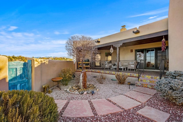 view of yard with a porch and fence