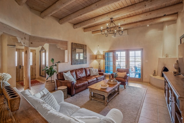 living area with light tile patterned floors, an inviting chandelier, beam ceiling, a fireplace with raised hearth, and wood ceiling