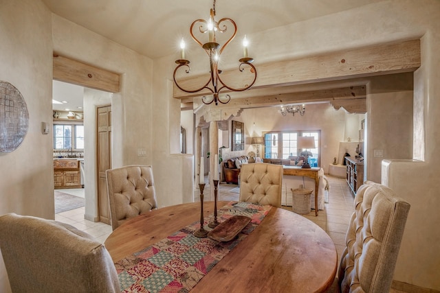 dining space with an inviting chandelier, light tile patterned floors, and plenty of natural light