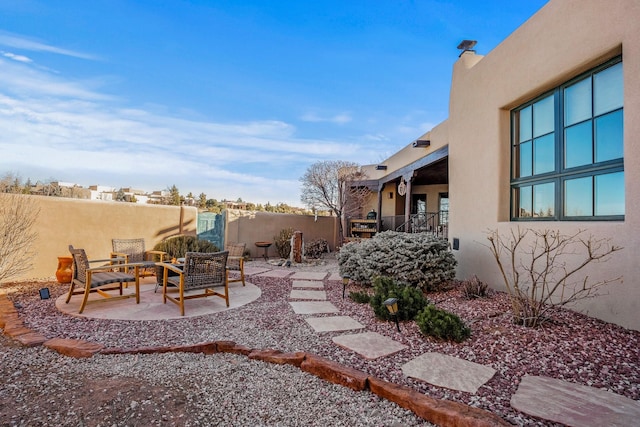 view of yard featuring a patio, fence, and an outdoor hangout area