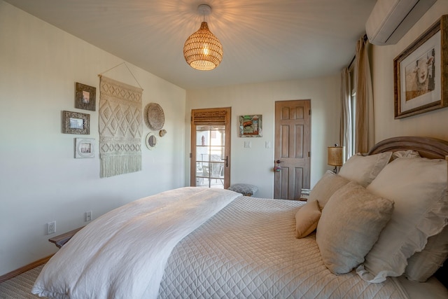 bedroom featuring a wall mounted air conditioner and baseboards