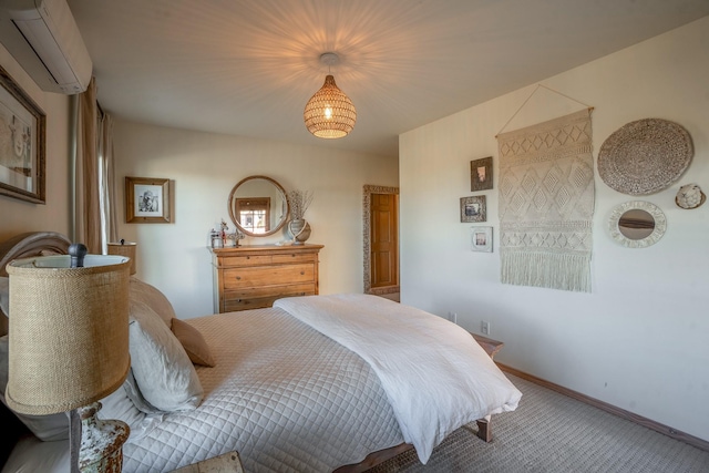 bedroom featuring carpet flooring, a wall mounted AC, and baseboards