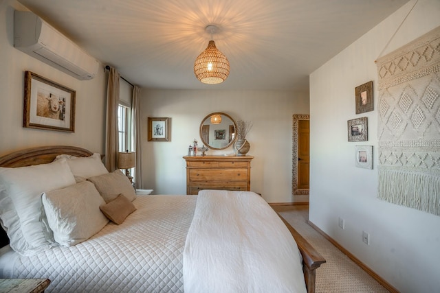 bedroom with a wall mounted AC, baseboards, and light carpet