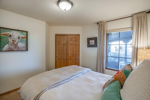 bedroom featuring a closet, carpet flooring, and baseboards