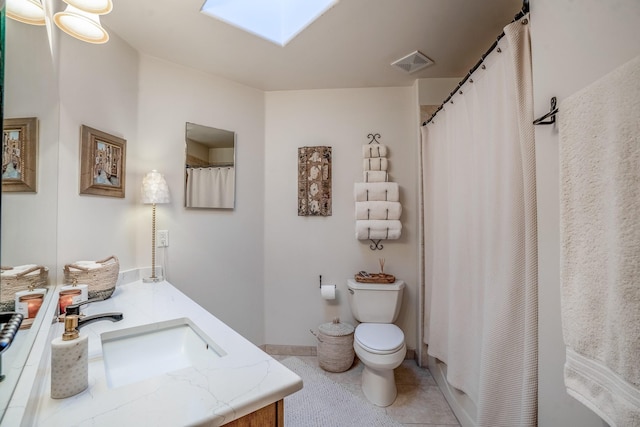 bathroom with visible vents, baseboards, toilet, a skylight, and vanity