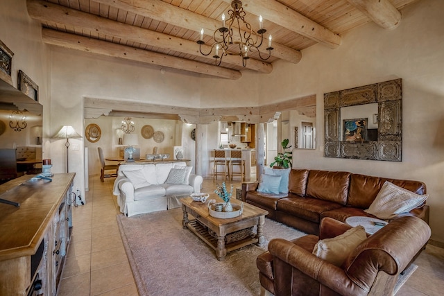 living room featuring beam ceiling, a towering ceiling, light tile patterned floors, wood ceiling, and a chandelier