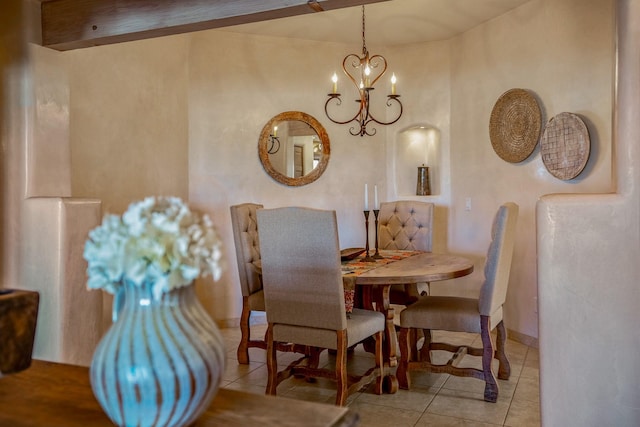 tiled dining room with an inviting chandelier and baseboards