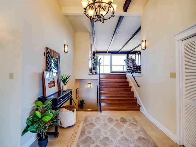 stairs with tile patterned floors, beamed ceiling, baseboards, and a chandelier