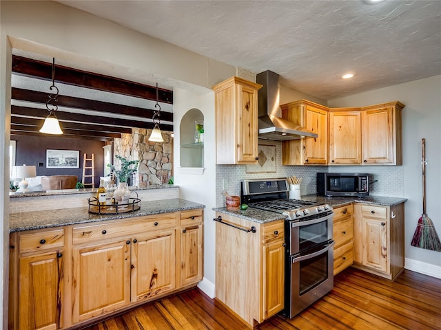 kitchen featuring tasteful backsplash, dark wood finished floors, stainless steel appliances, and wall chimney range hood