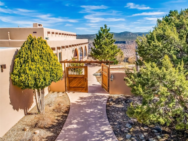 exterior space featuring a mountain view and fence