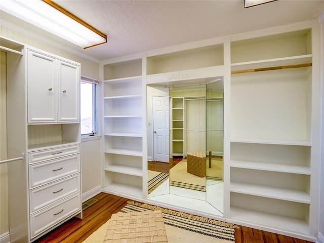 walk in closet featuring visible vents and wood finished floors