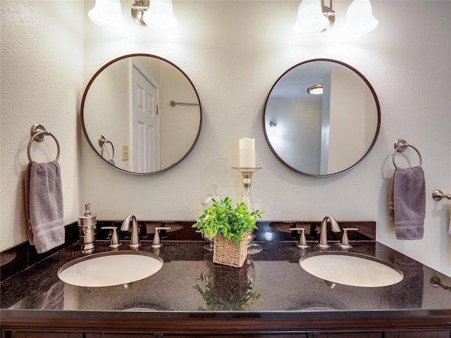 bathroom featuring a sink and double vanity