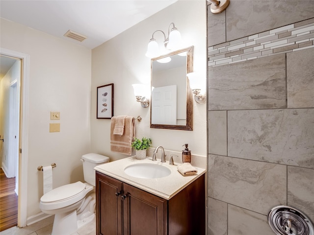 bathroom with vanity, toilet, visible vents, and tile patterned flooring