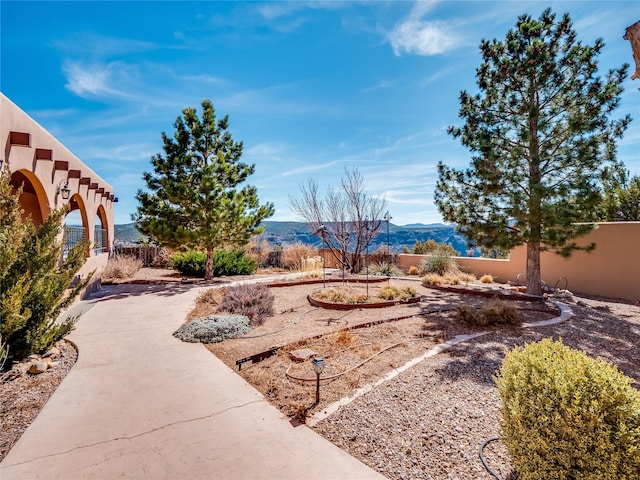 view of yard with a mountain view and fence