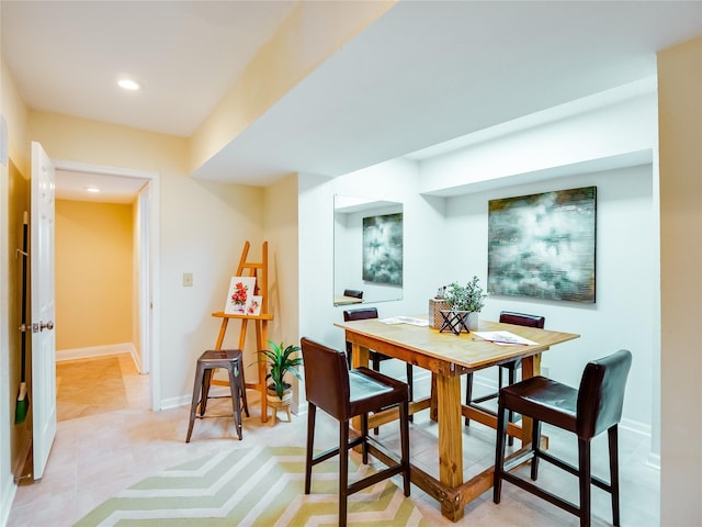 dining space featuring light tile patterned flooring, recessed lighting, and baseboards