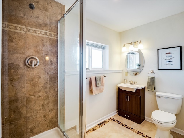 full bathroom with vanity, toilet, baseboards, and a stall shower