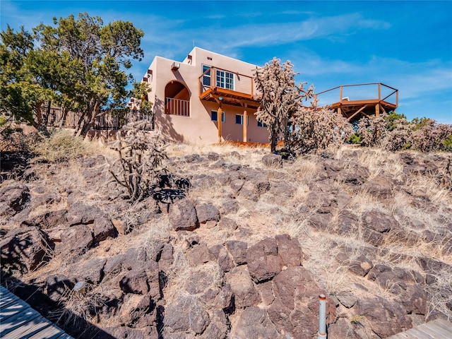 back of property featuring stucco siding