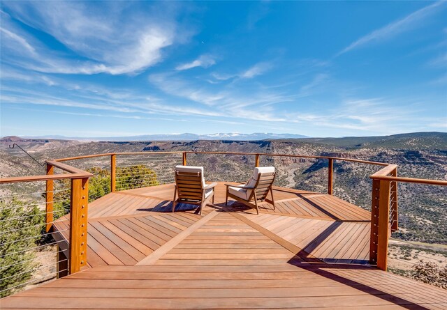 wooden deck featuring a mountain view