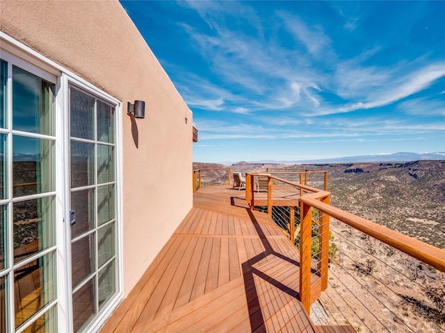 wooden deck featuring a mountain view