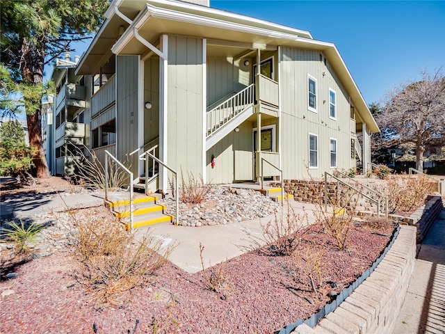 view of building exterior featuring entry steps and stairway