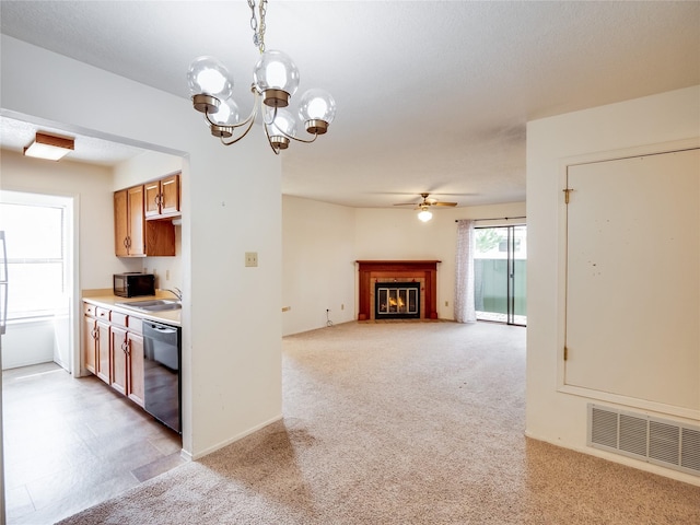 kitchen with light carpet, visible vents, black appliances, and a fireplace with flush hearth