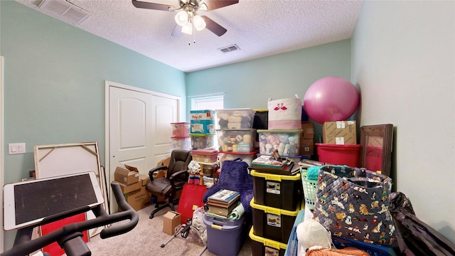 interior space featuring carpet, visible vents, and a textured ceiling