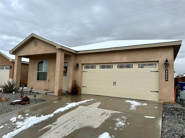 view of front of home featuring an attached garage and stucco siding