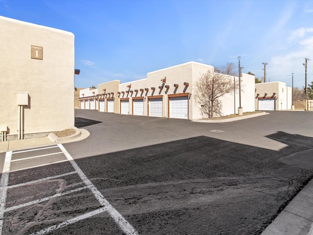 exterior space featuring community garages and stucco siding
