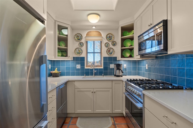 3101 Old Pecos Trl Unit 219, Santa Fe, NM 87505 - kitchen with backsplash, appliances with stainless steel finishes, light countertops, and a sink
