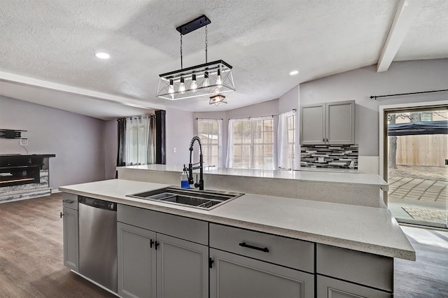 kitchen featuring a sink, vaulted ceiling with beams, dishwasher, and gray cabinets