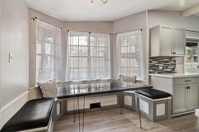 dining area featuring lofted ceiling and wood finished floors