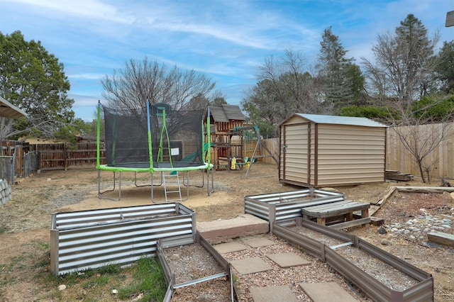 view of yard with a trampoline, a fenced backyard, a playground, a shed, and an outdoor structure