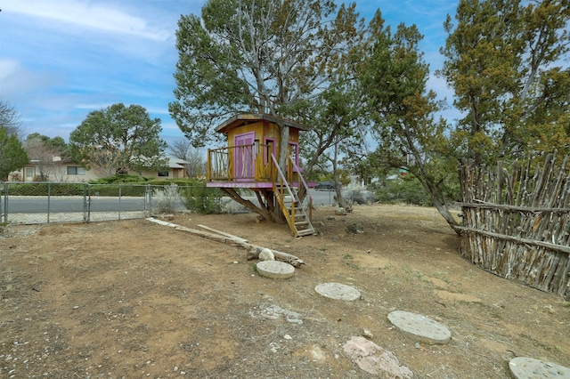 view of yard featuring a playground and fence