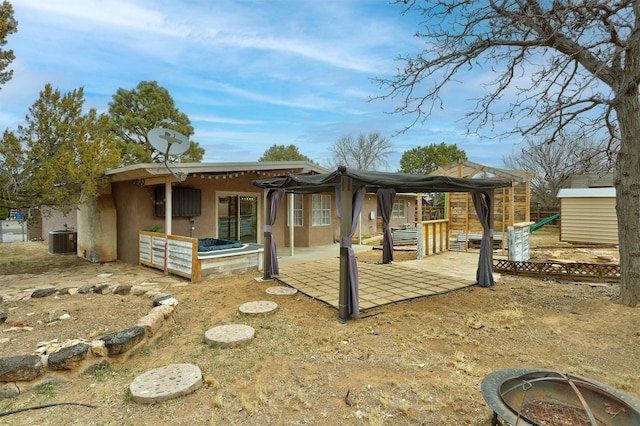 view of home's exterior with a patio, cooling unit, a shed, stucco siding, and an outdoor structure