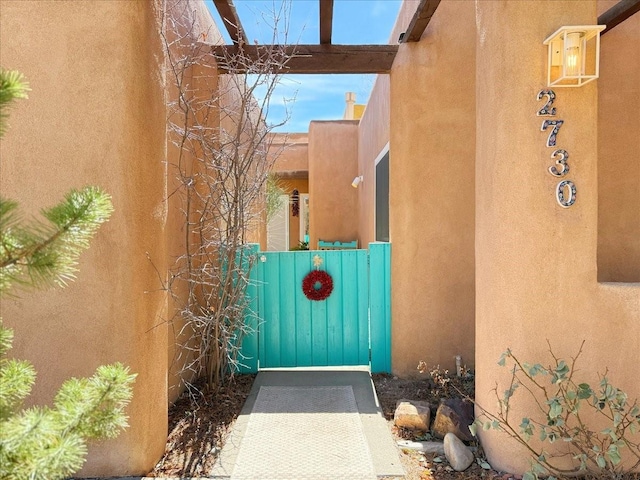 property entrance with stucco siding