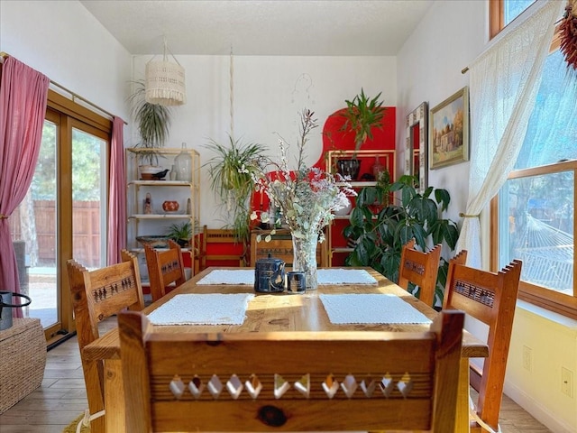 dining space with wood finished floors