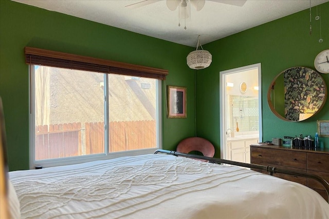 bedroom with ensuite bath and ceiling fan